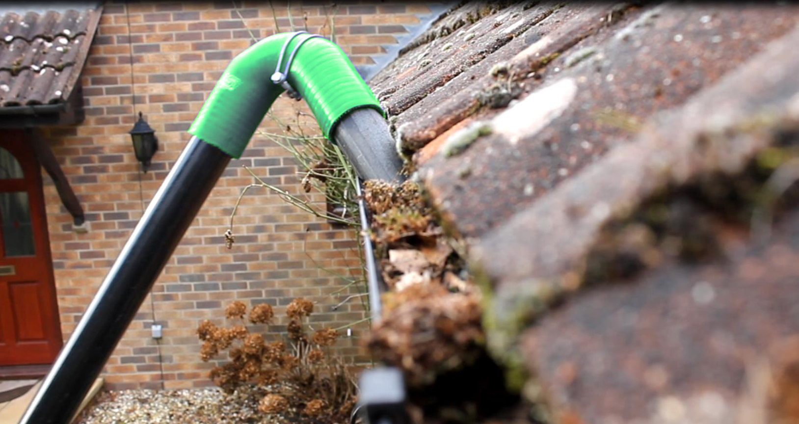 Professional gutter vacuum cleaning in action