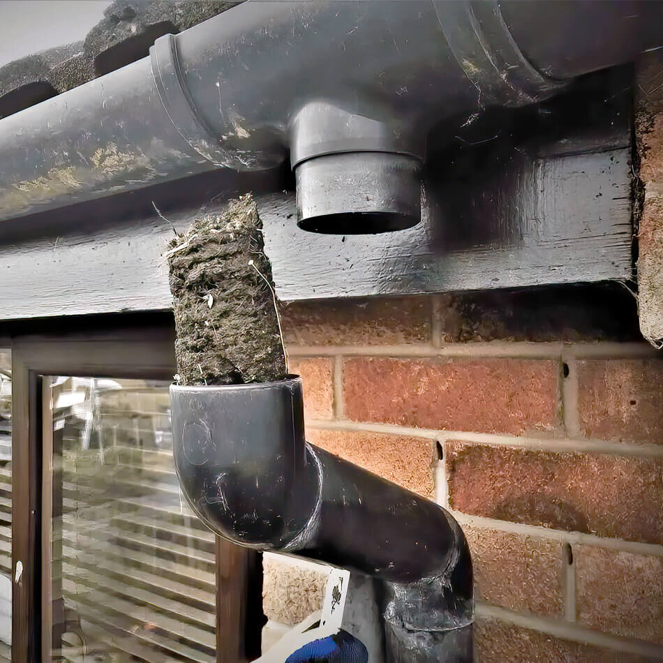 Blocked residential gutter downpipe and outlet