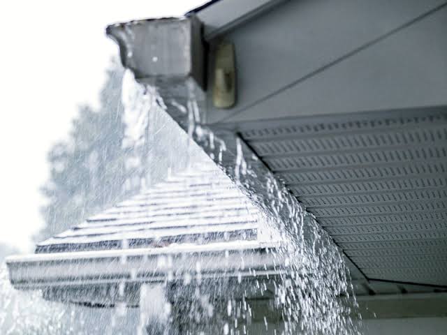 Overflowing gutter allowing rainwater to spill over the edge of the guttering